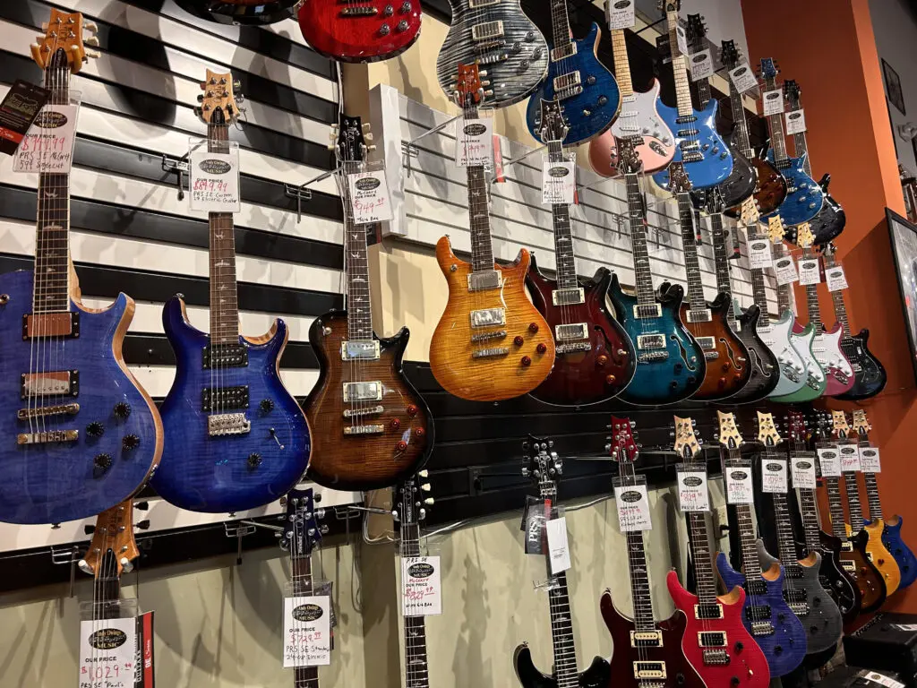 So many guitars hanging at the shop for sale