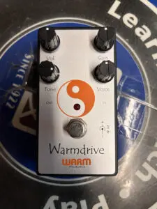 A Warm Audio Warmdrive pedal with a yin - yang symbol on it.