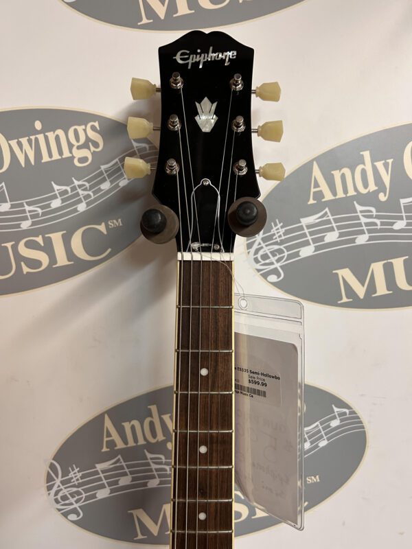 A guitar with a logo on the front of it.