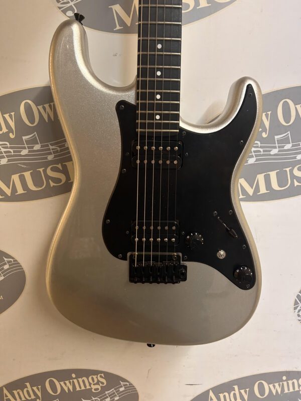A silver electric guitar with a logo on it.