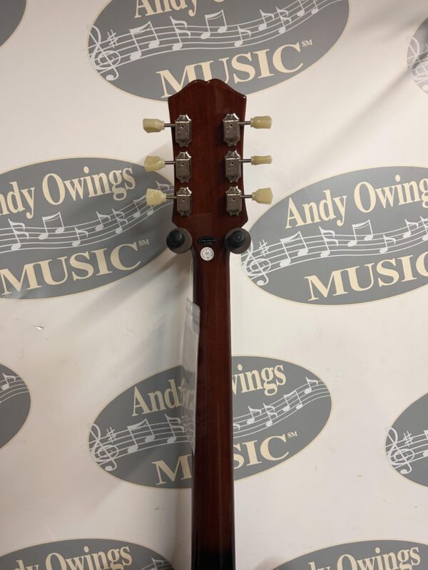 An acoustic guitar with a logo on it.