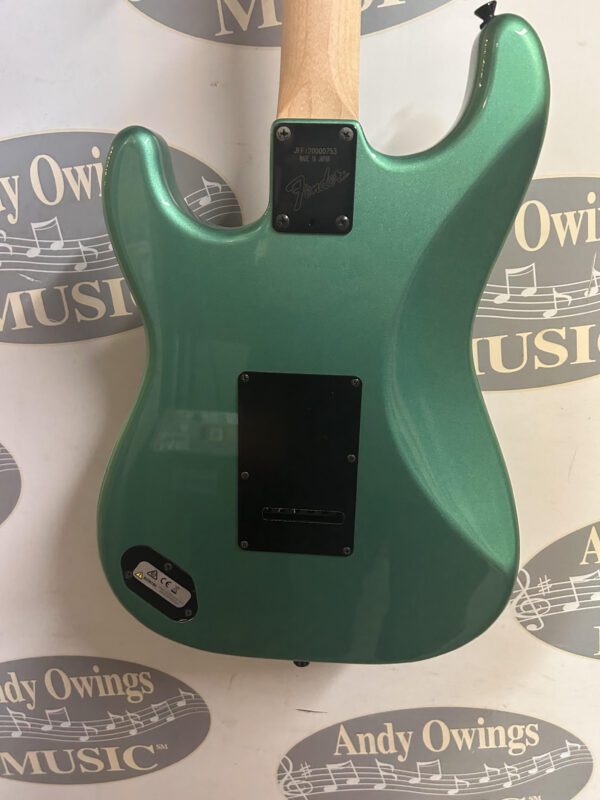 A green electric guitar with a logo on it.