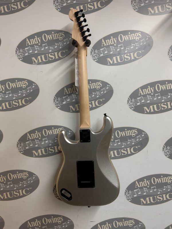 A silver electric guitar with a logo on it.