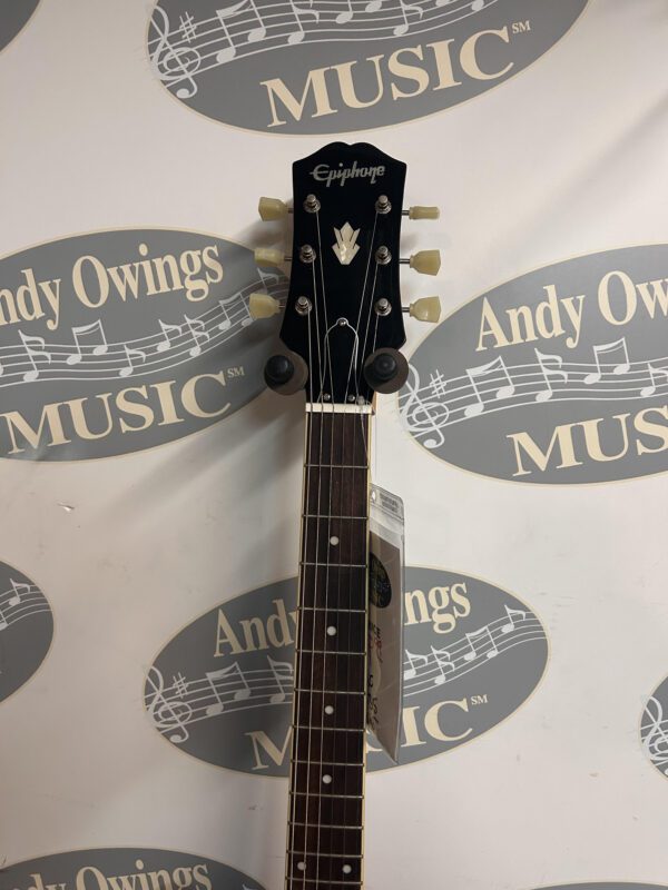 An andy owens guitar with a logo on it.