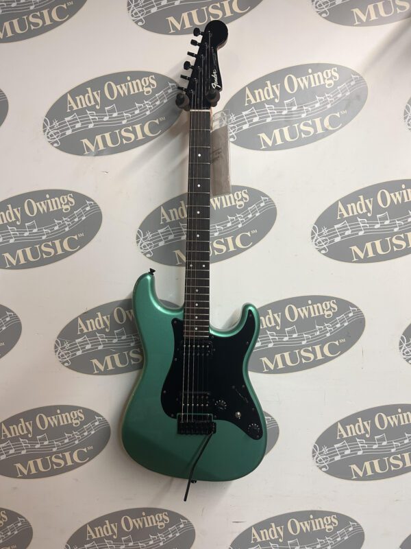 A green electric guitar with a logo on it.