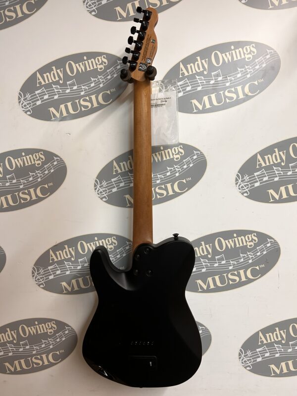A black electric guitar with a logo on it.