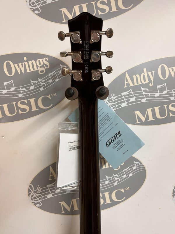 A black guitar with a label on it.