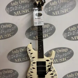 A white electric guitar with a tag on it.