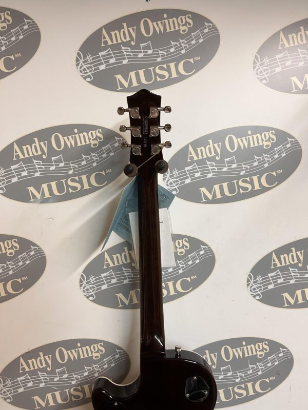 A black guitar with a label on it.