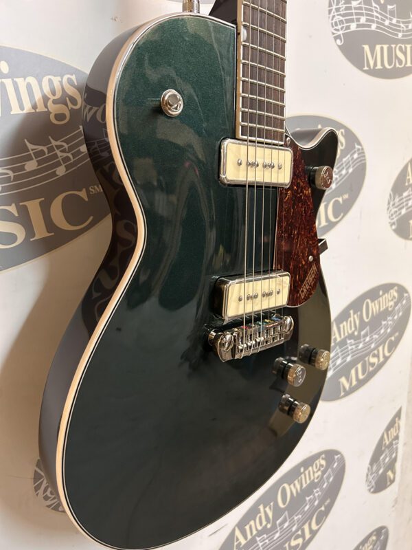 A black and green electric guitar with a logo on it.