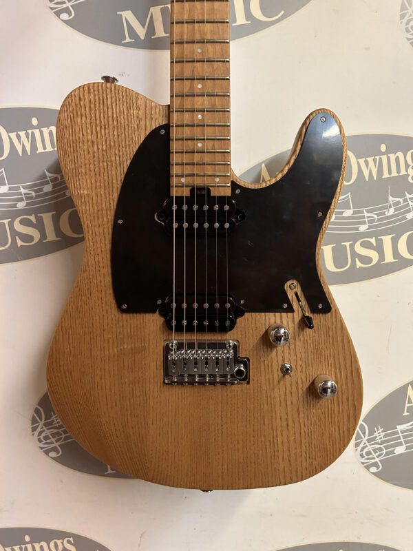 A guitar with a wooden body and a black neck.